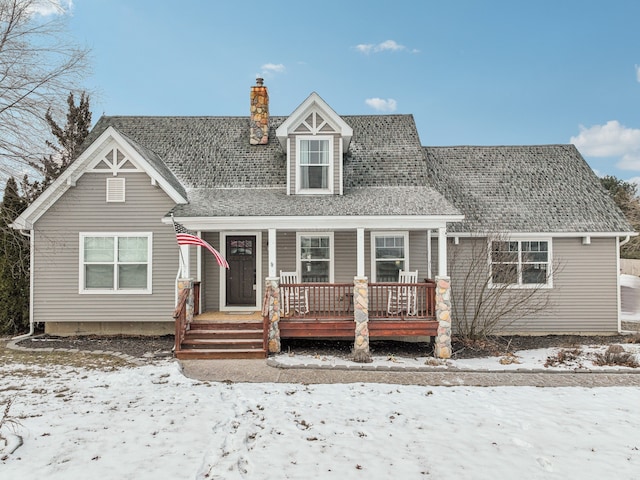 new england style home featuring covered porch