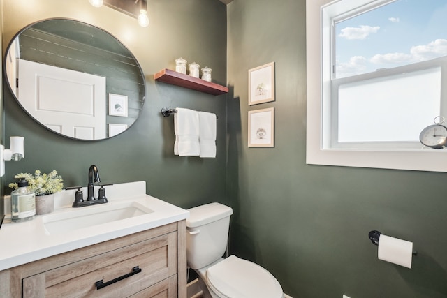 bathroom featuring toilet and vanity