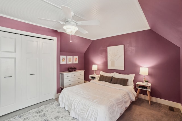 bedroom featuring ceiling fan, light colored carpet, vaulted ceiling, and a closet