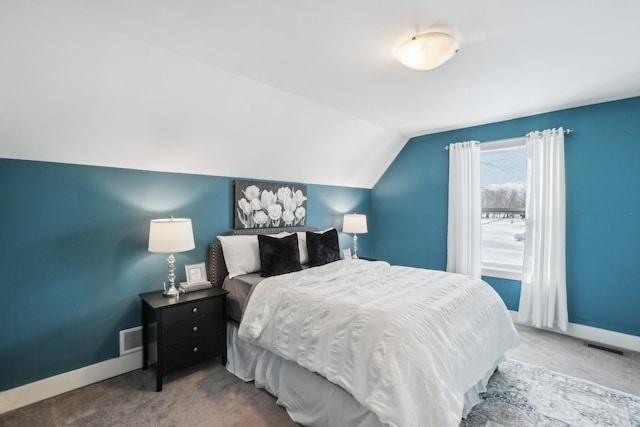 bedroom featuring lofted ceiling and carpet floors