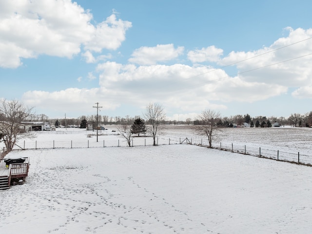 snowy yard featuring a rural view