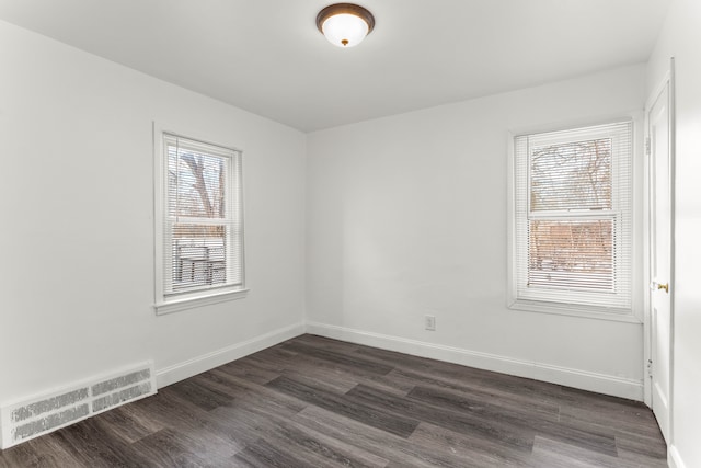 empty room with dark wood-type flooring