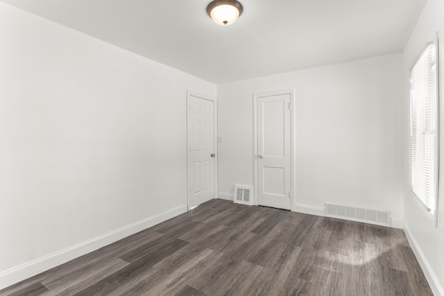 unfurnished room featuring dark wood-type flooring