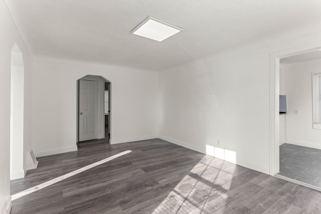 spare room with dark hardwood / wood-style floors