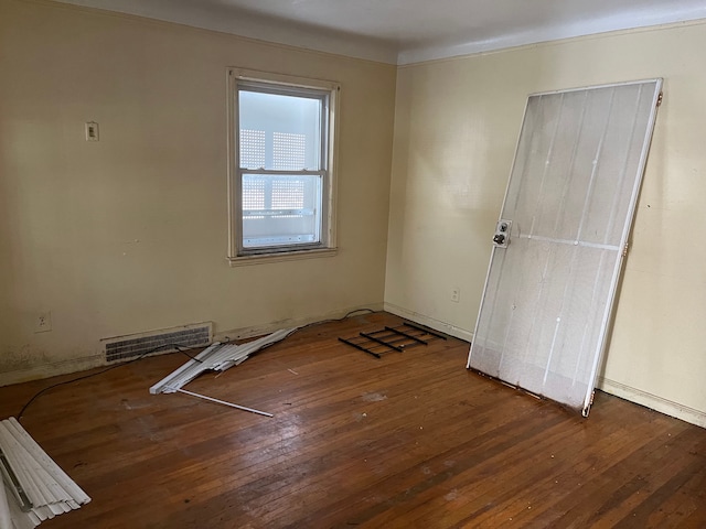 empty room with hardwood / wood-style flooring