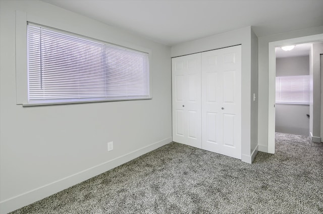 unfurnished bedroom with a closet and carpet