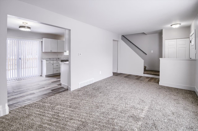 unfurnished living room with light carpet