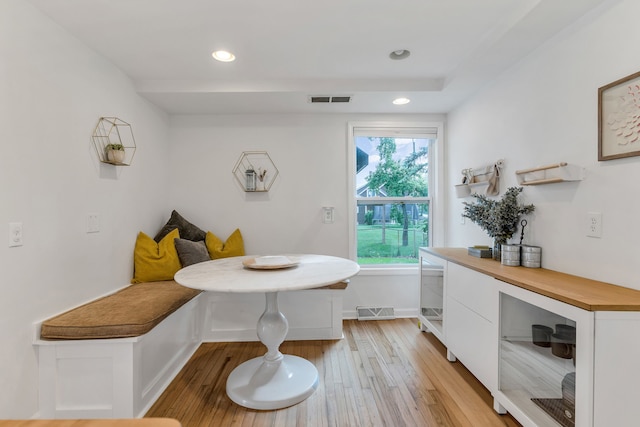 dining space with light wood-type flooring and breakfast area