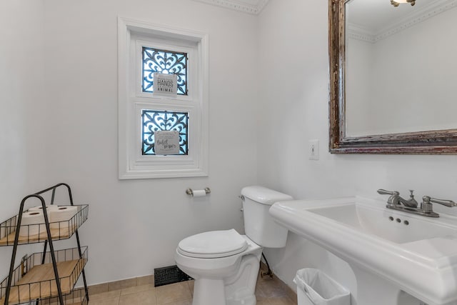 bathroom featuring tile patterned flooring, sink, ornamental molding, and toilet