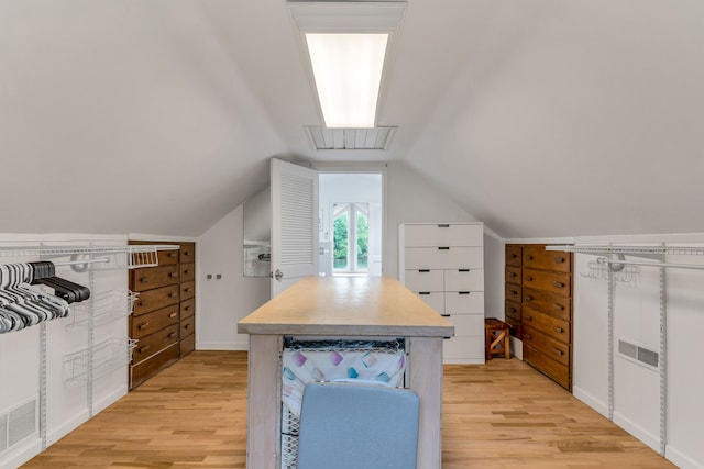 spacious closet featuring lofted ceiling and light hardwood / wood-style floors