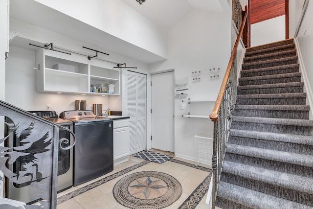 laundry room with cabinets, separate washer and dryer, sink, and light tile patterned floors