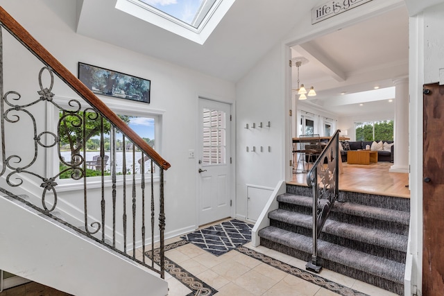 entrance foyer featuring a skylight and light tile patterned floors