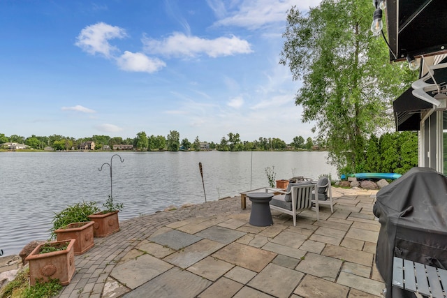 view of patio / terrace featuring a grill and a water view