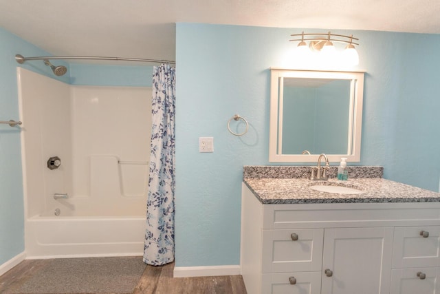 bathroom featuring shower / tub combo, hardwood / wood-style flooring, and vanity