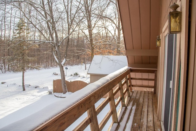 view of snow covered back of property