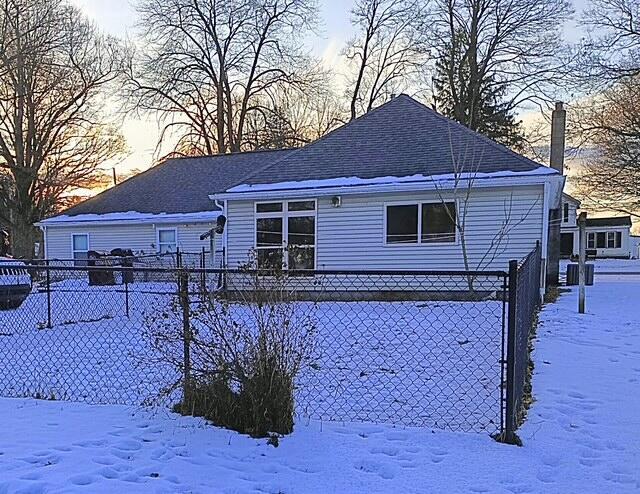 view of snow covered rear of property