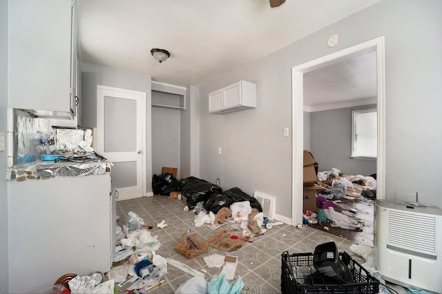 interior space featuring white cabinetry and heating unit