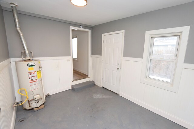 interior space with water heater and a wealth of natural light