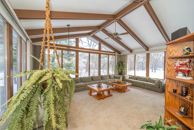 sunroom with ceiling fan and vaulted ceiling with beams