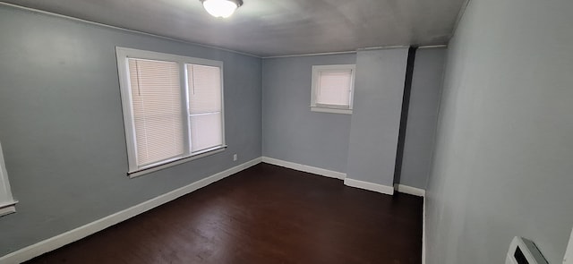 unfurnished room featuring dark hardwood / wood-style flooring