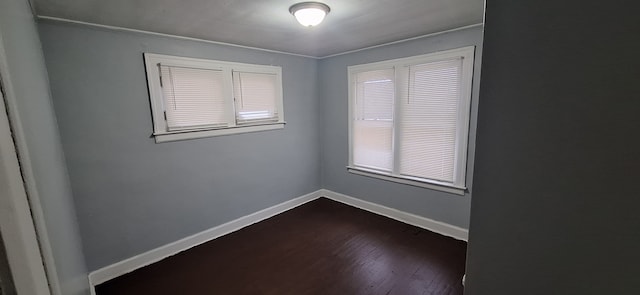 unfurnished room with dark hardwood / wood-style flooring