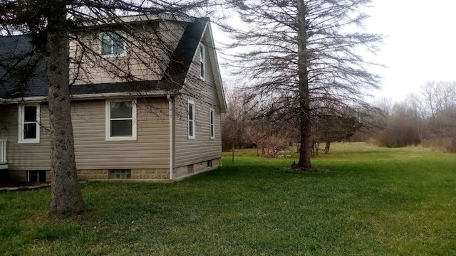 view of side of home with a lawn