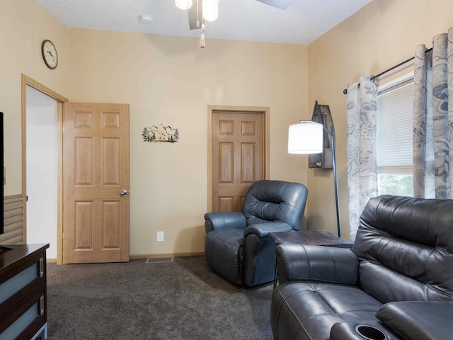 carpeted living room with ceiling fan