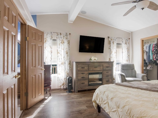 bedroom with ceiling fan, dark hardwood / wood-style floors, a closet, and lofted ceiling with beams