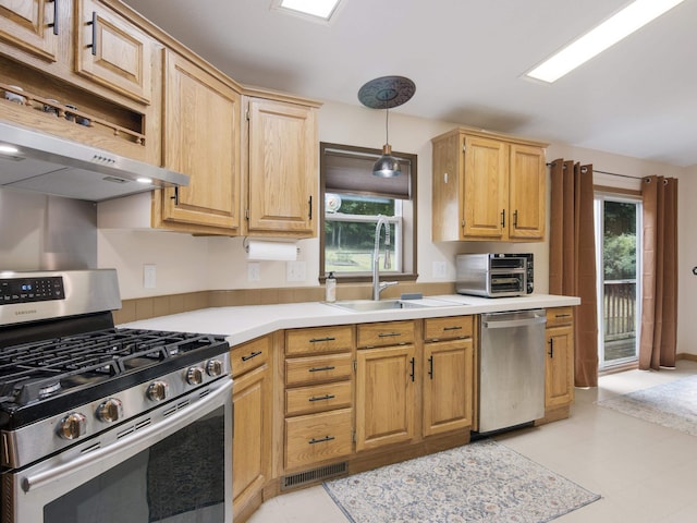 kitchen with pendant lighting, sink, a wealth of natural light, and stainless steel appliances