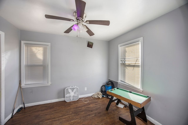 rec room with ceiling fan and dark hardwood / wood-style flooring