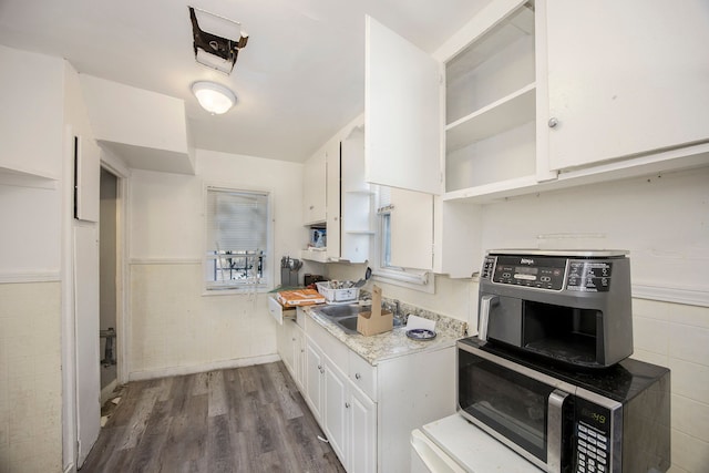 kitchen featuring white cabinetry, sink, and dark wood-type flooring