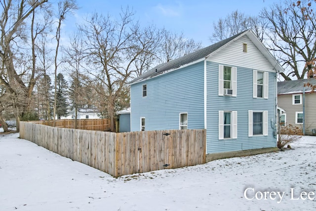 view of snow covered back of property