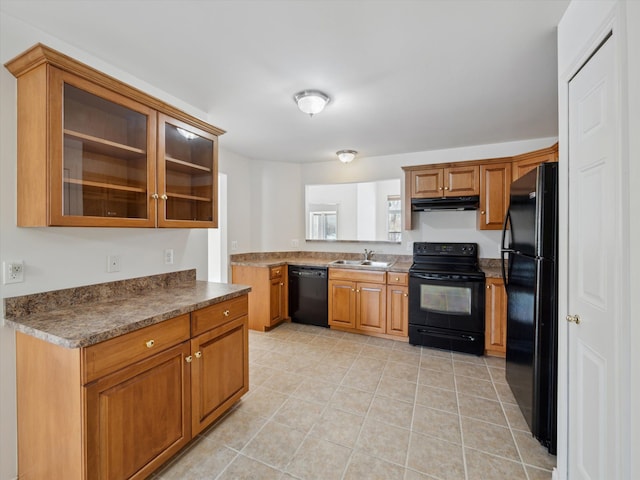 kitchen featuring a sink, under cabinet range hood, black appliances, and brown cabinetry