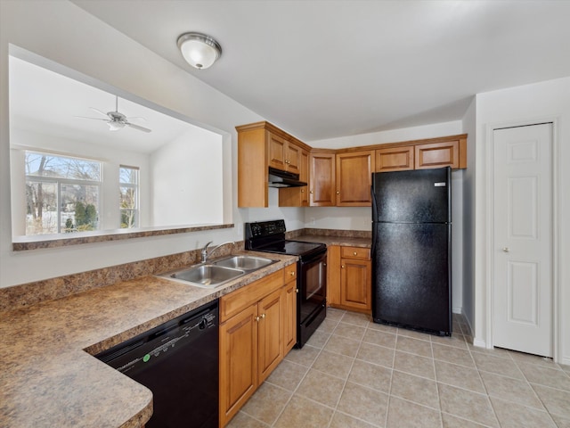 kitchen featuring under cabinet range hood, a sink, light tile patterned flooring, black appliances, and brown cabinetry