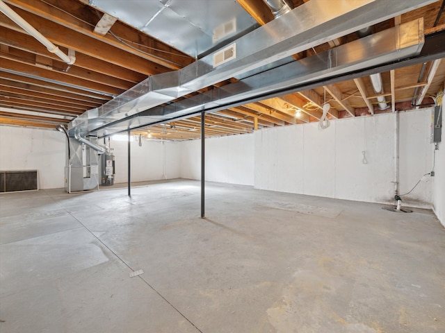 unfinished below grade area with visible vents, heating unit, and gas water heater