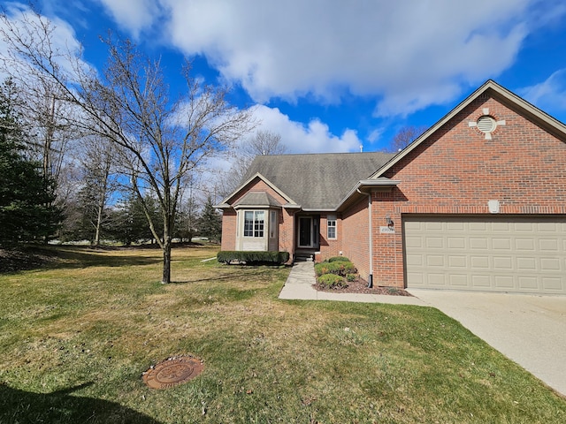 view of front of property with roof with shingles, an attached garage, driveway, a front yard, and brick siding