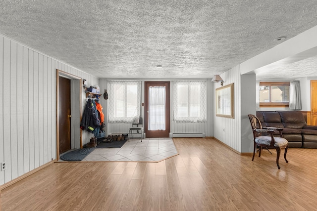 42891 Bemis Rd, Sumpter, MI 48111 - entryway with a baseboard heating unit, light hardwood / wood-style floors, and wooden walls