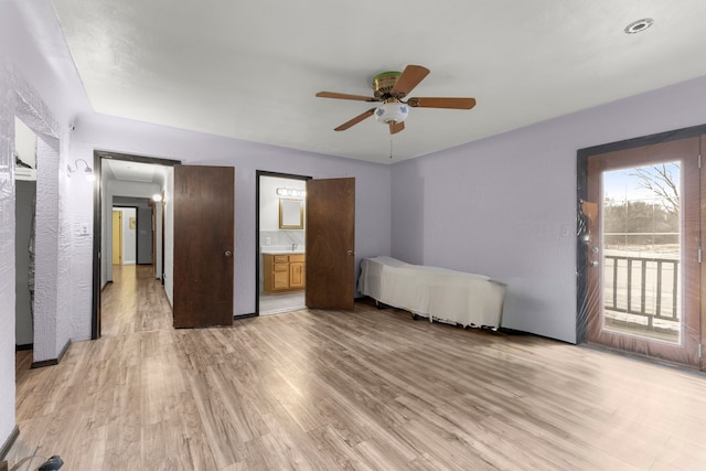 42891 Bemis Rd, Sumpter, MI 48111 - unfurnished bedroom with ensuite bathroom, ceiling fan, access to exterior, and light hardwood / wood-style flooring