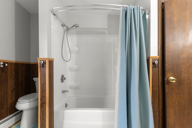 42891 Bemis Rd, Sumpter, MI 48111 - bathroom with shower / bath combo, a baseboard heating unit, wood walls, and toilet