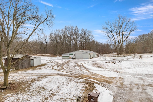 42891 Bemis Rd, Sumpter, MI 48111 - snowy yard with a garage and an outbuilding