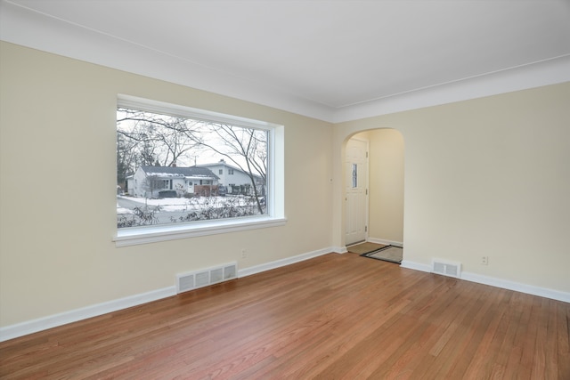 unfurnished room with wood-type flooring