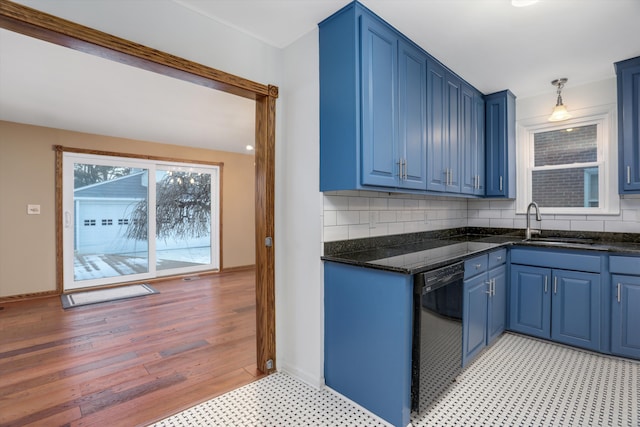 kitchen with sink, backsplash, black dishwasher, and blue cabinets