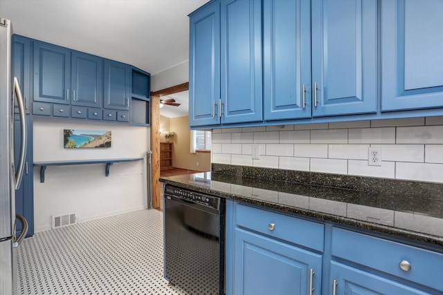 kitchen featuring black dishwasher, dark stone countertops, blue cabinets, and stainless steel fridge