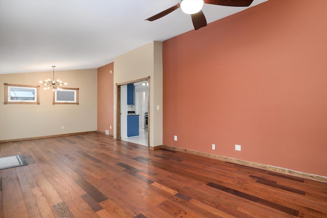 spare room featuring hardwood / wood-style flooring, lofted ceiling, and ceiling fan with notable chandelier