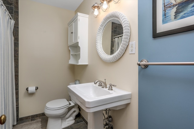 bathroom featuring toilet, a shower with curtain, and tile patterned floors