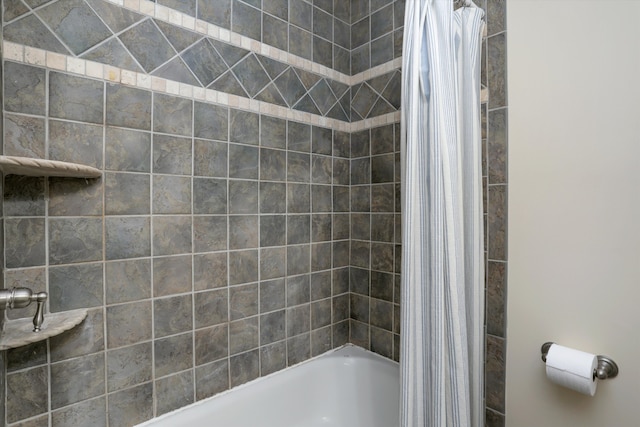 bathroom with shower / bathtub combination with curtain