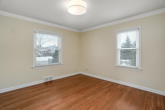 unfurnished room featuring hardwood / wood-style flooring and ornamental molding