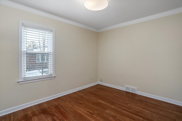 unfurnished room featuring dark wood-type flooring and ornamental molding