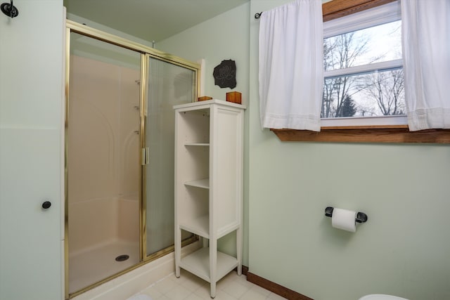 bathroom with a shower with door