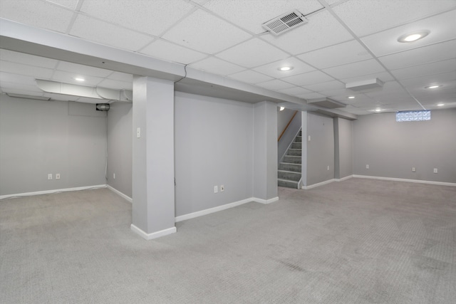 basement with a drop ceiling and carpet flooring